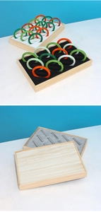 Detail of wooden jewelry tray with velvet slots for displaying bangles and bracelets
