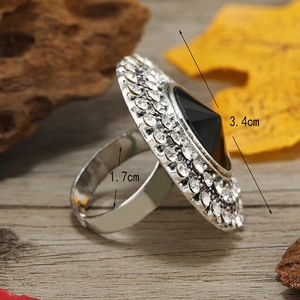 Detail view of large retro round ring with black stone and measurement labels