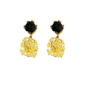 Vintage irregular golden lion head stud earrings with black circular top on white background