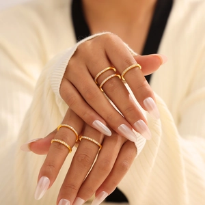 Set of 18k gold plated stainless steel geometric rings with cubic zirconia on female hand
