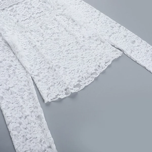Vue macro détaillée du tissu en dentelle florale blanche et de l'ourlet délicat du haut
