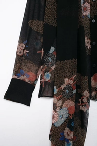 Close-up of lightweight chiffon fabric with vintage floral print and sheer texture
