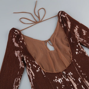 Detail of sequin party dress featuring backless cutout and adjustable lace-up ties