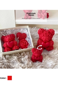 Detail of red rose-textured bear candles with hearts in elegant gift box packaging