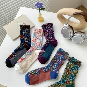 Detail of five pairs of vintage floral cotton socks with embossed patterns and contrast colors