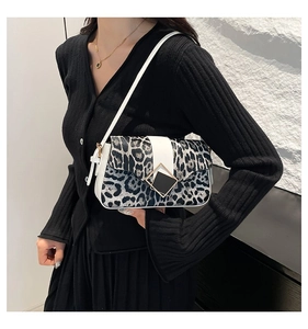 Detail of leopard print shoulder bag with metallic buckle and contrast stitching