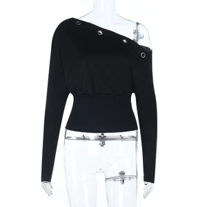 Close-up of black off-shoulder top featuring silver eyelet details and ribbed waist cuff