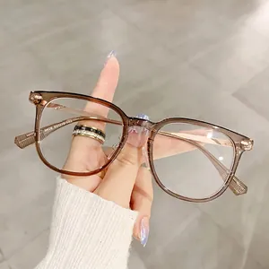 Classic square frame glasses in transparent brown acetate with slim gold metal temples