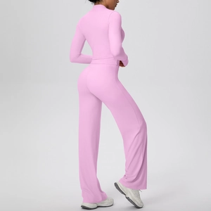 Detail of pink ribbed knit yoga set showing slim fit jacket and wide leg pants texture