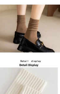Detailed close-up of brown and white ribbed knit crew socks with soft cotton texture