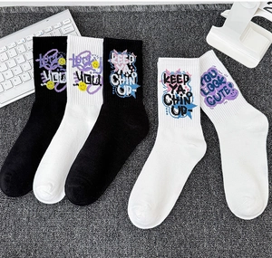 Detail of athletic mid-calf socks with graffiti prints like Lucky You and smiley icons