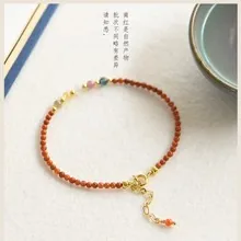 Macro shot of Nanhong agate beaded bracelet with gold clasp and colorful accents