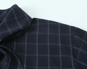 Detail of navy blue plaid poplin shirt showing precise stitching and fabric texture