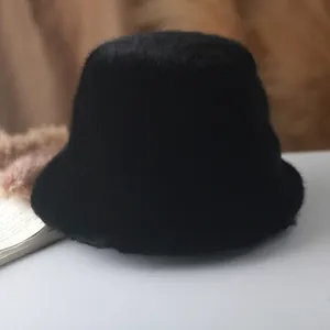 Detail of soft black faux fur bucket hat with dense texture for winter warmth