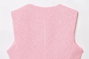 Close-up of pink tweed fabric texture and back seam on this stylish women's vest