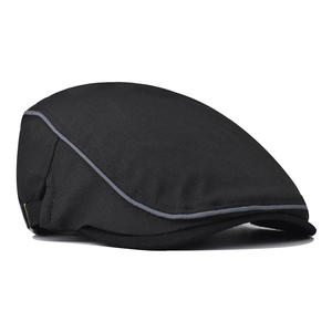Detailed side view of black cotton flat cap with stylish gray piping and stitching