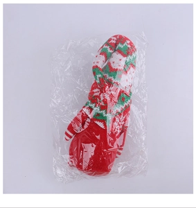 Close-up of a festive Christmas knitted doll accessory in vibrant red, green, and white