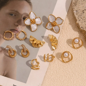 Detail of 18K gold-plated geometric petal earrings and luxury jewelry collection display