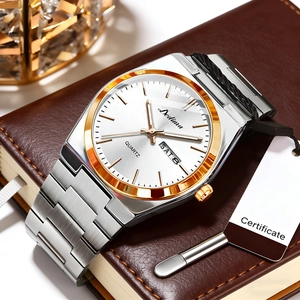 Macro shot of silver and gold stainless steel men's watch with day-date display dial