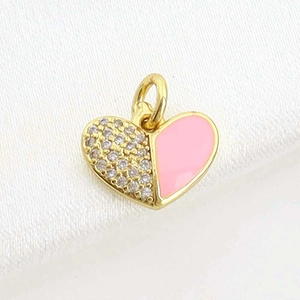 Pink enamel and rhinestone heart pendant on white silk background for jewelry DIY