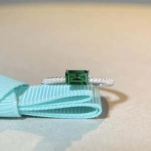 Elegant S925 silver emerald ring featuring a green square stone with a halo of micro diamonds