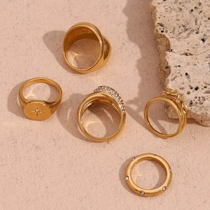 Detailed set of five 18K gold plated stainless steel rings with floral and star motifs