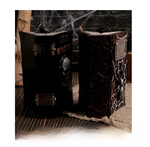 Gothic resin book ornaments featuring skull relief and spider webs for Halloween decor