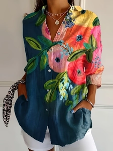 Detail of vibrant watercolor floral print shirt with buttons and functional chest pockets