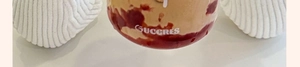 Close-up of the GÜCCRES branded heat-resistant glass cup base with creative dessert layers