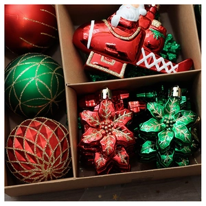 Detailed overhead view of red and green festive Christmas ornaments in a kraft paper gift box