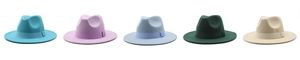 Flat lay of multiple wool fedora hats in blue, purple, and green with decorative ribbons