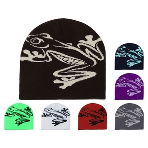 Detail view of colorful knitted beanies with artistic frog pattern in various color options