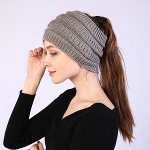 Detail of light coffee knitted ponytail headband showing thick texture and open top design
