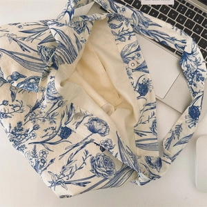 Detail of blue tulip printed canvas bag showing magnetic metal buckle and soft inner lining