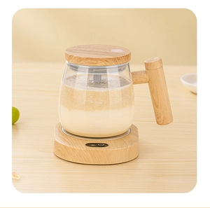 Detail of 400ml glass cup with wooden lid on a matching heated coaster base