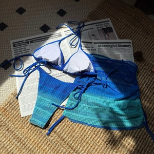 Detailed view of 3-piece gradient mesh bikini set with textured fabric on rustic background