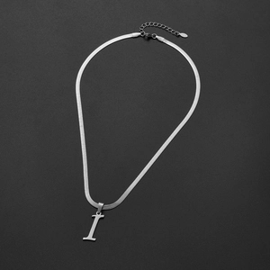 Close-up of polished silver snake chain with minimalist capital letter I pendant