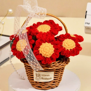 Detail of crochet sunflower basket with red and yellow knitted flowers and lace ribbon
