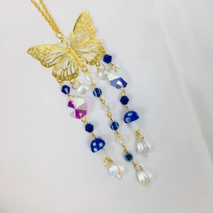Gold hollow butterfly car pendant with blue mushrooms, crystals and blue-white beads