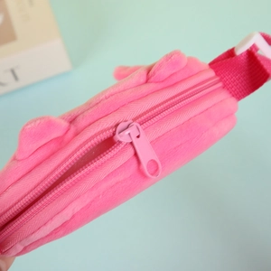 Close-up of soft pink plush fabric texture and sturdy zipper detail on kid's small bag