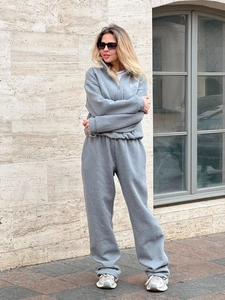 Grey American retro sporty tracksuit with zip-up sweatshirt and joggers on model