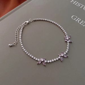 Detail of silver chain bracelet with purple zircon butterflies and lobster clasp