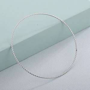 Minimalist 65x1mm silver stainless steel twisted rope bangle shown from a side angle