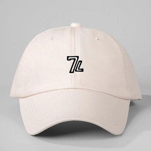 Detailed close-up of 7L logo embroidery on the front of a cotton twill baseball cap