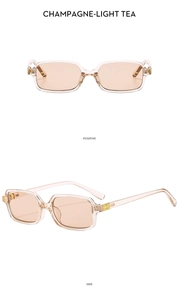 Detail view of champagne square sunglasses with golden metal logo and light tea lenses