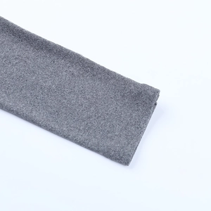 Gros plan sur la texture du tricot gris montrant les coutures fines des poignets