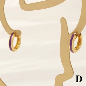 Detail of 18K gold-plated hoops with purple enamel inlay on elegant jewelry stand