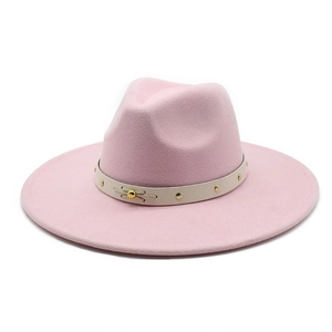 Detail view of pink wool felt fedora with studded leather band and gold metal trim