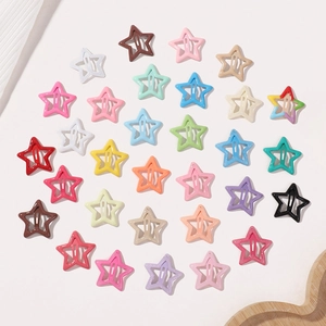 Star-shaped snap hair clips in various bright candy colors with a glossy lacquer finish