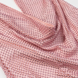 Close-up of pink mesh fabric top with sparkling rhinestones in a trendy design